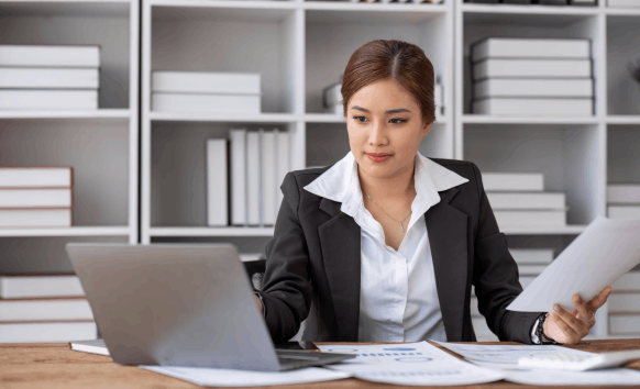 Translator working on translating various documents such as birth certificates, marriage records, and immigration papers.